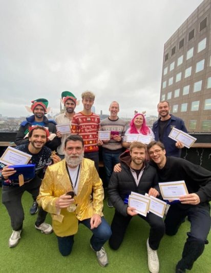Part of the Creative CX team at the London Rooftop bar holding their winning certificates.