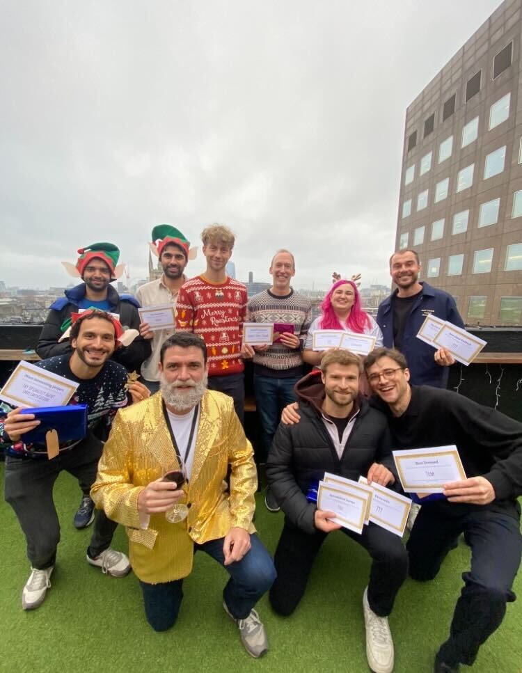 Part of the Creative CX team at the London Rooftop bar holding their winning certificates.