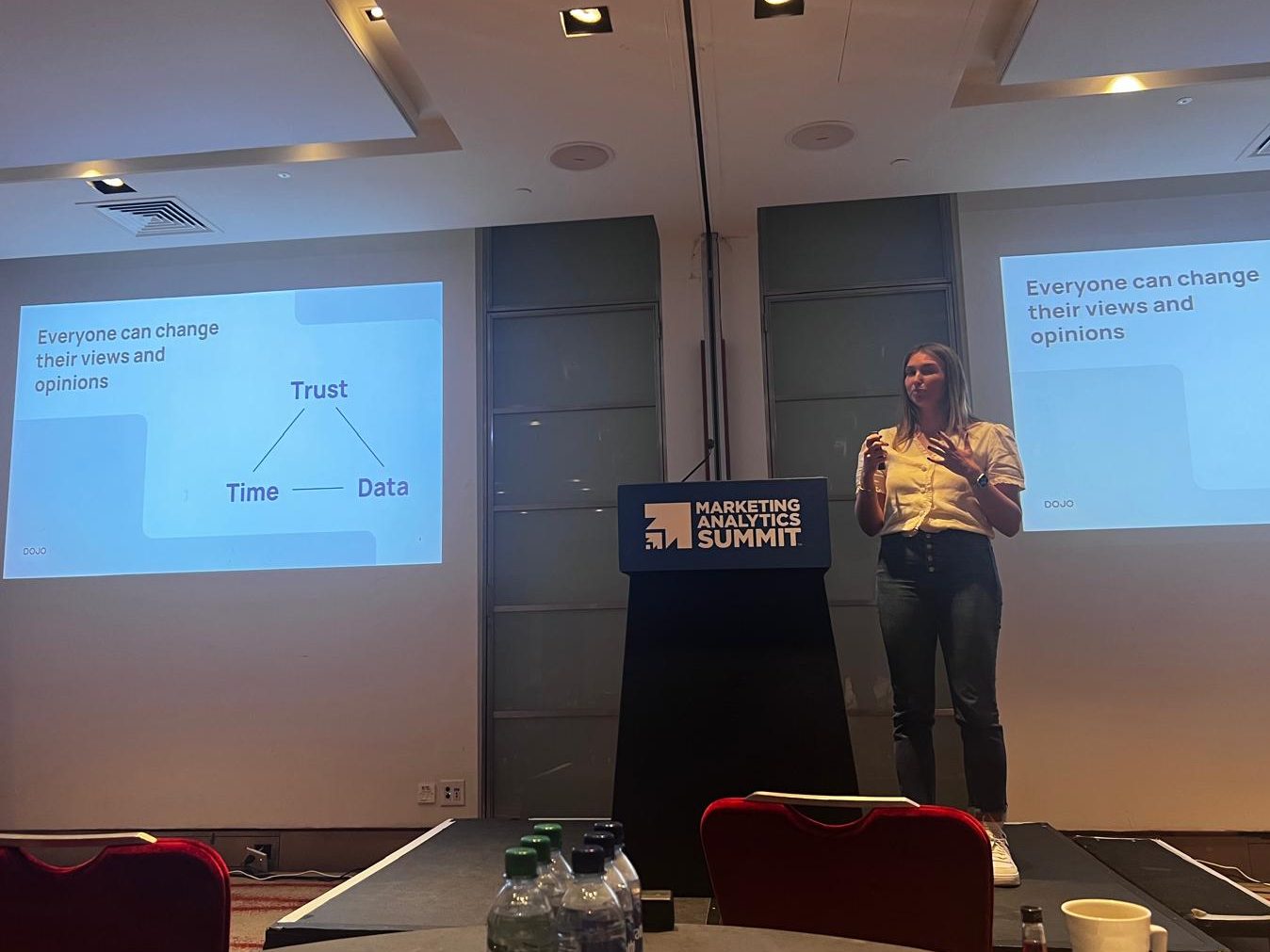 Scarlett's talk, 'From Numbers to Revenue." 

The slide states: 'Everyone can change their views and opinions,' and shows a 3 point triangulation of trust, time, and data. 