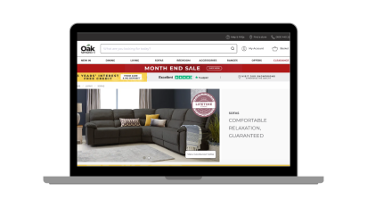 A laptop frame with the oak furnitureland sofa category shown on the screen.