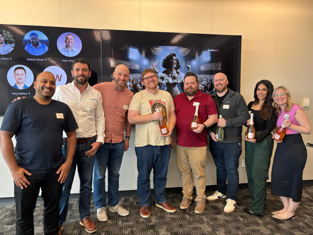 The winning team posing with their prosecco bottles